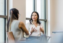 A person sitting on a chair Description automatically generated with low confidence