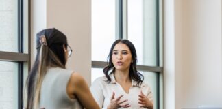 A person sitting on a chair Description automatically generated with low confidence