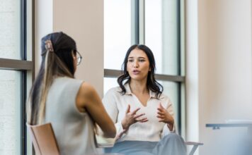 A person sitting on a chair Description automatically generated with low confidence